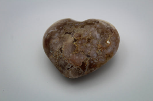 Polished flower agate in the shape of a heart.