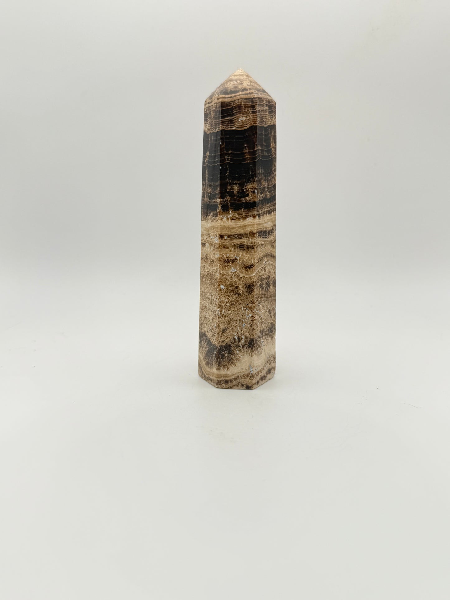 Polished chocolate calcite crystal tower. about 5 inches tall.