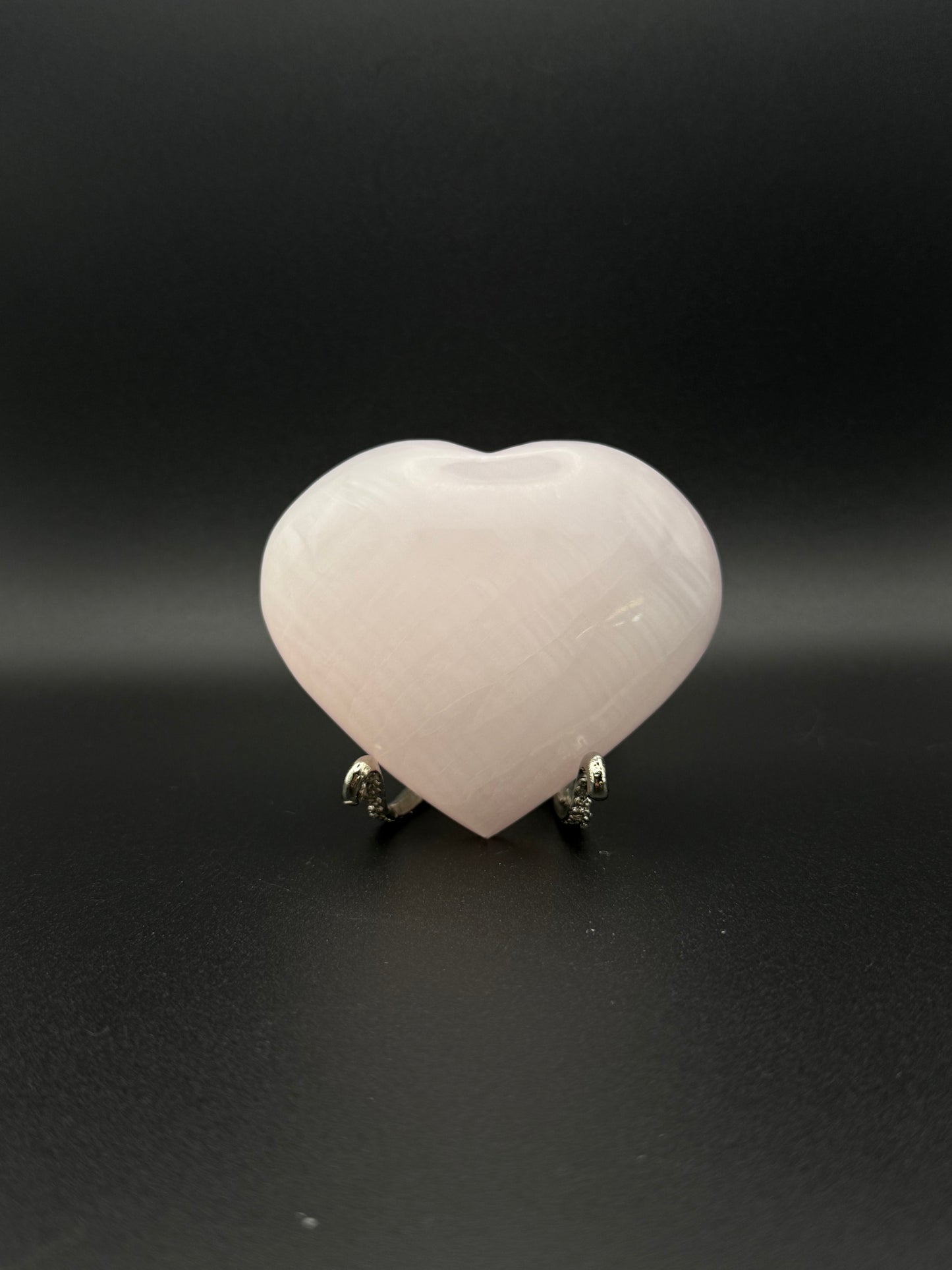 Polished pink calcite heart. Pink calcite glows under uv light.