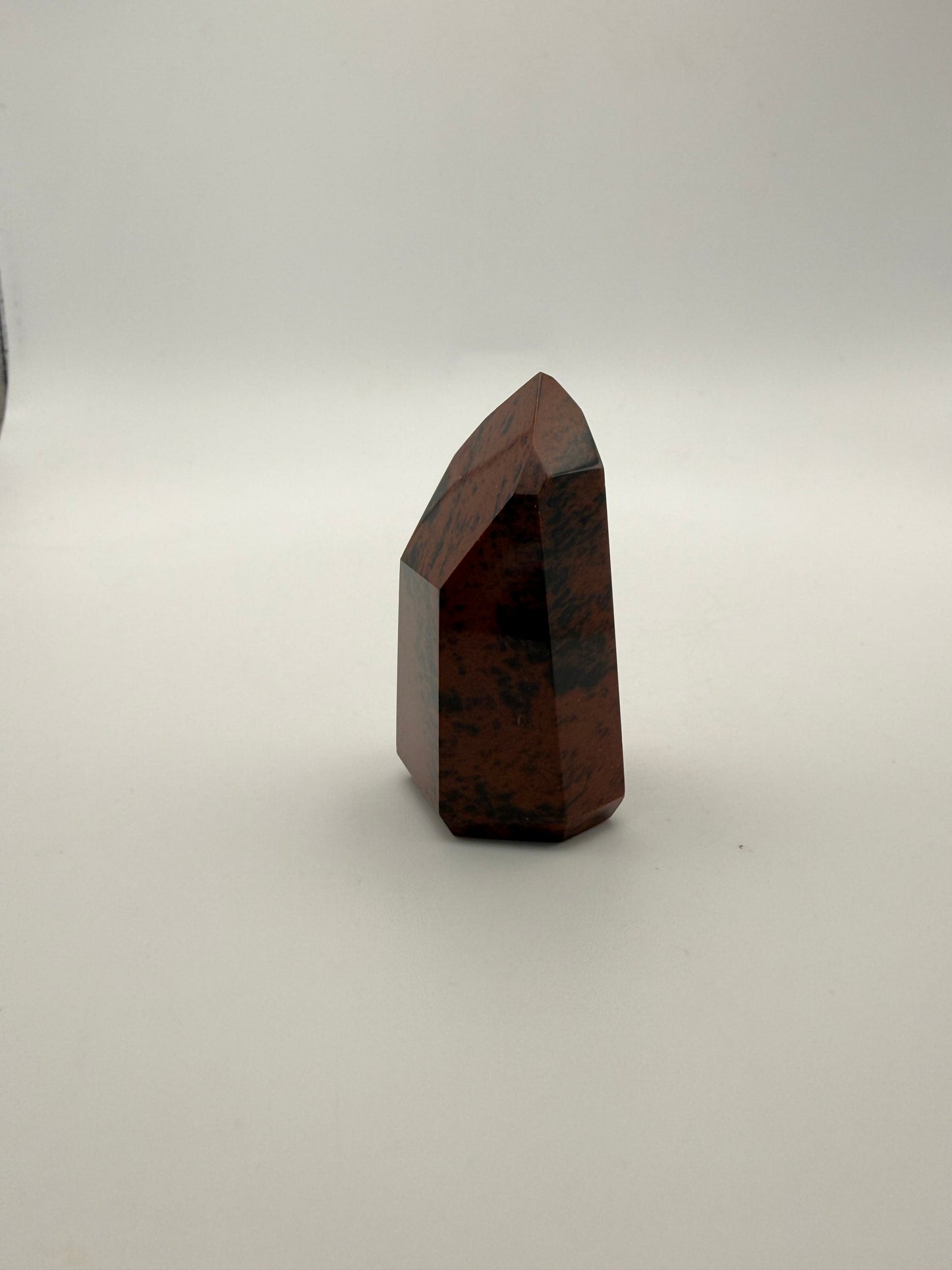 Polished mahogany obsidian tower with six sides.