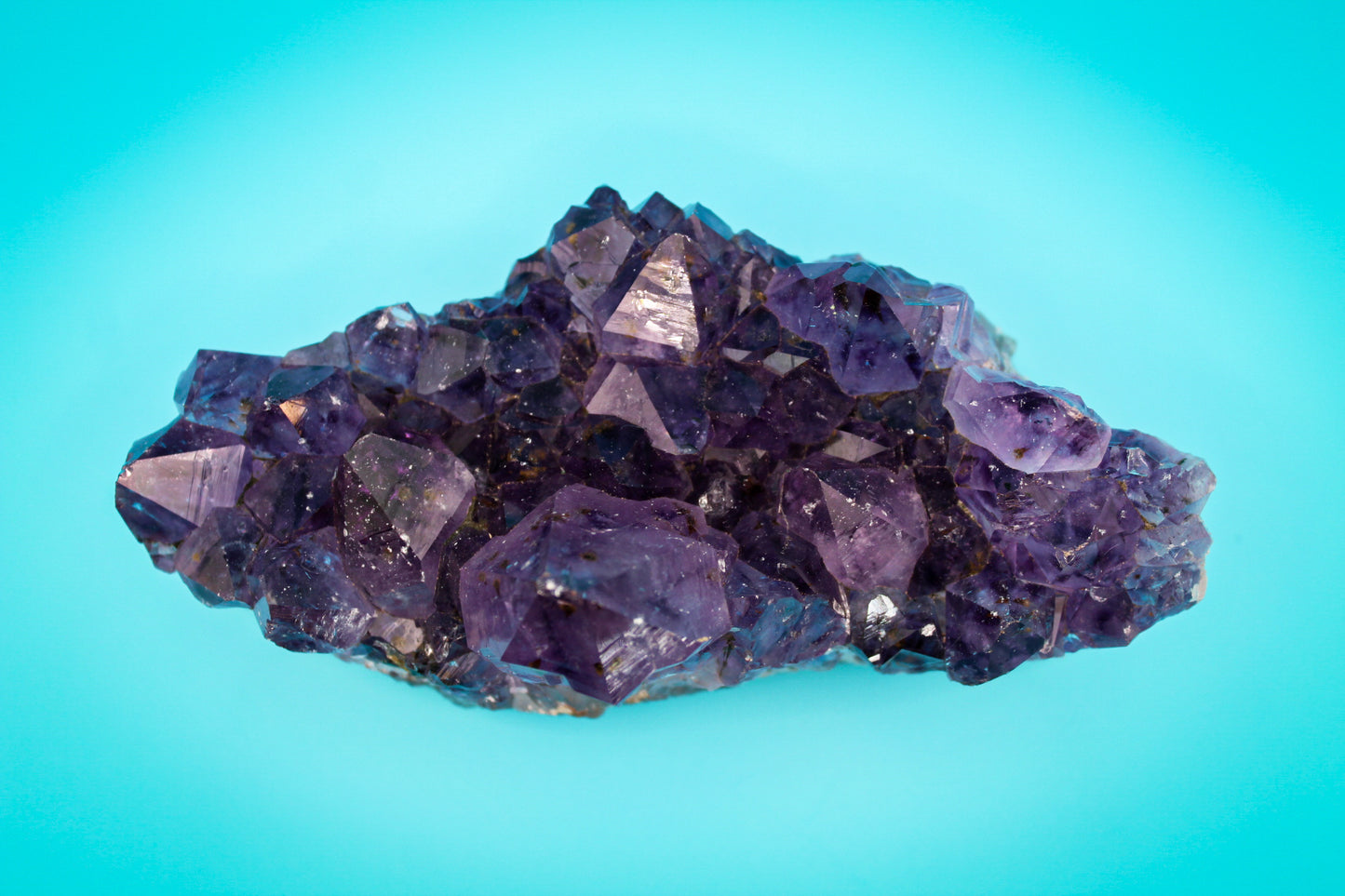 A cluster of amethyst crystals with a deep purple color.