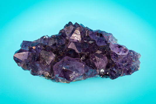 A cluster of amethyst crystals with a deep purple color.