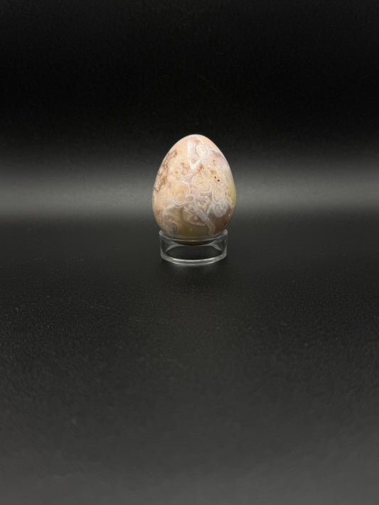 Polished flower agate crystal in the shape of an egg.
