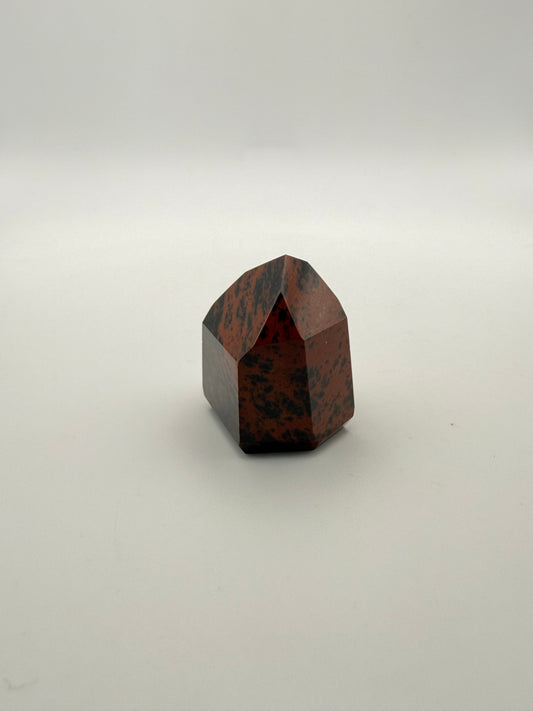 Polished mahogany obsidian tower with six sides.