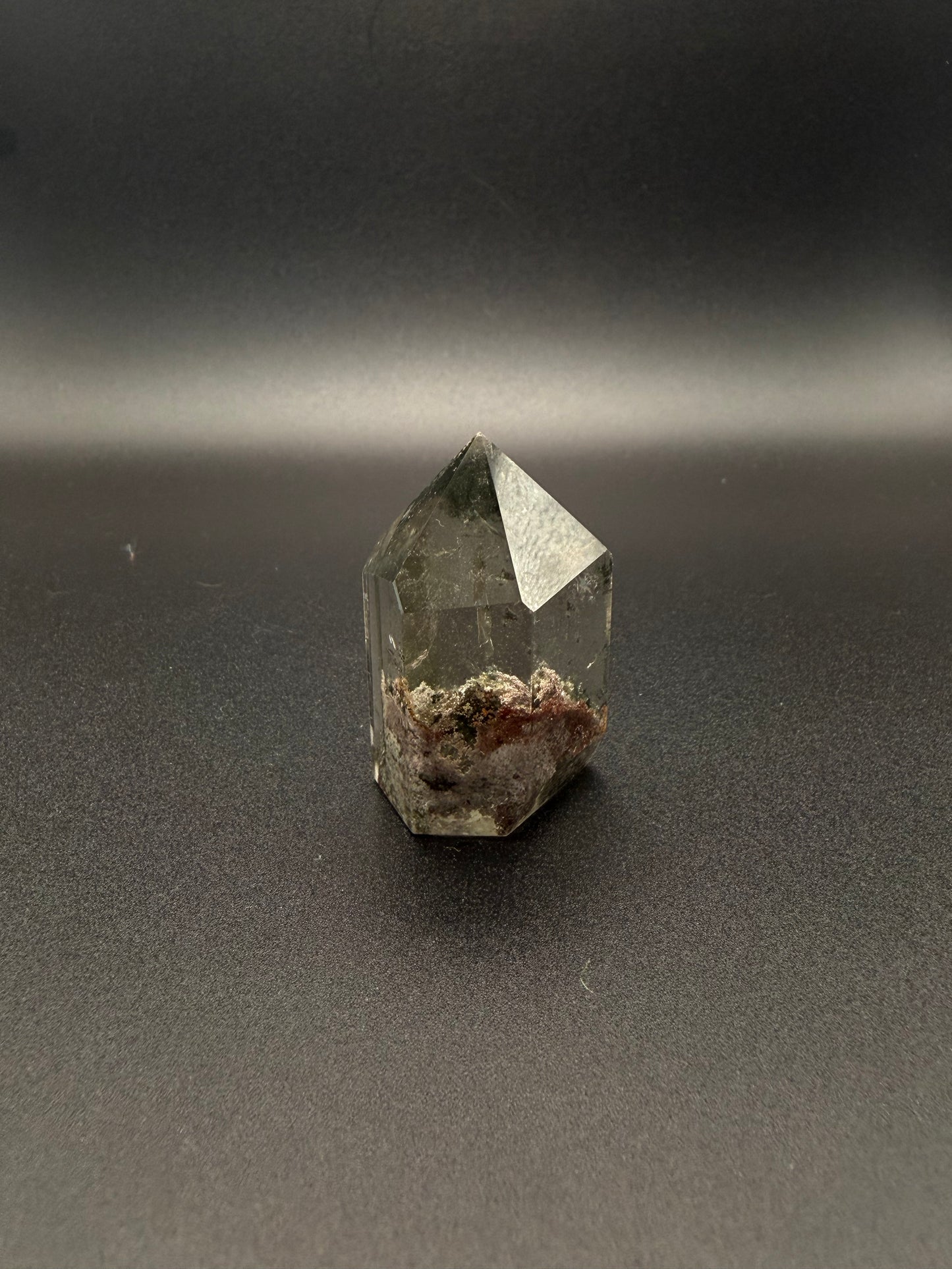 Polished garden quartz crystal tower with six sides.
