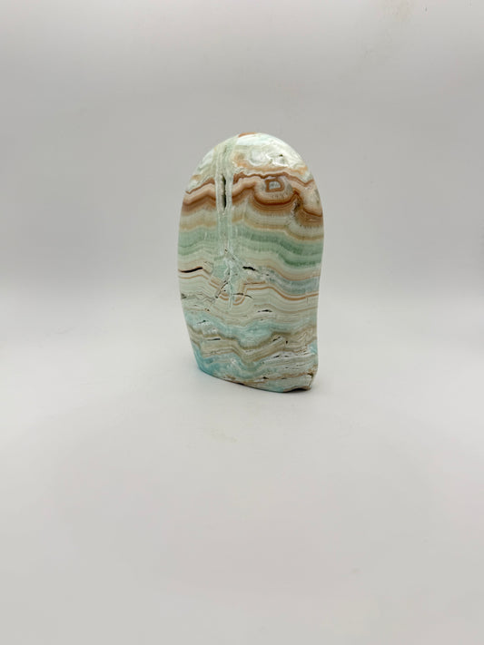 Caribbean calcite polished crystal free form in the shape of a dome.