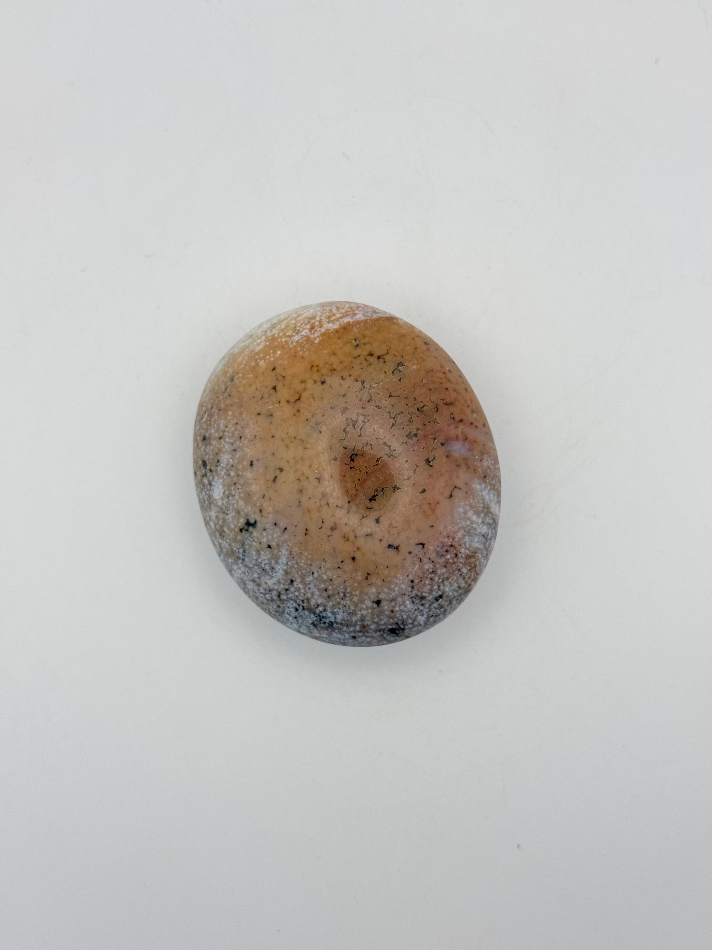Polished ocean jasper palm stone.