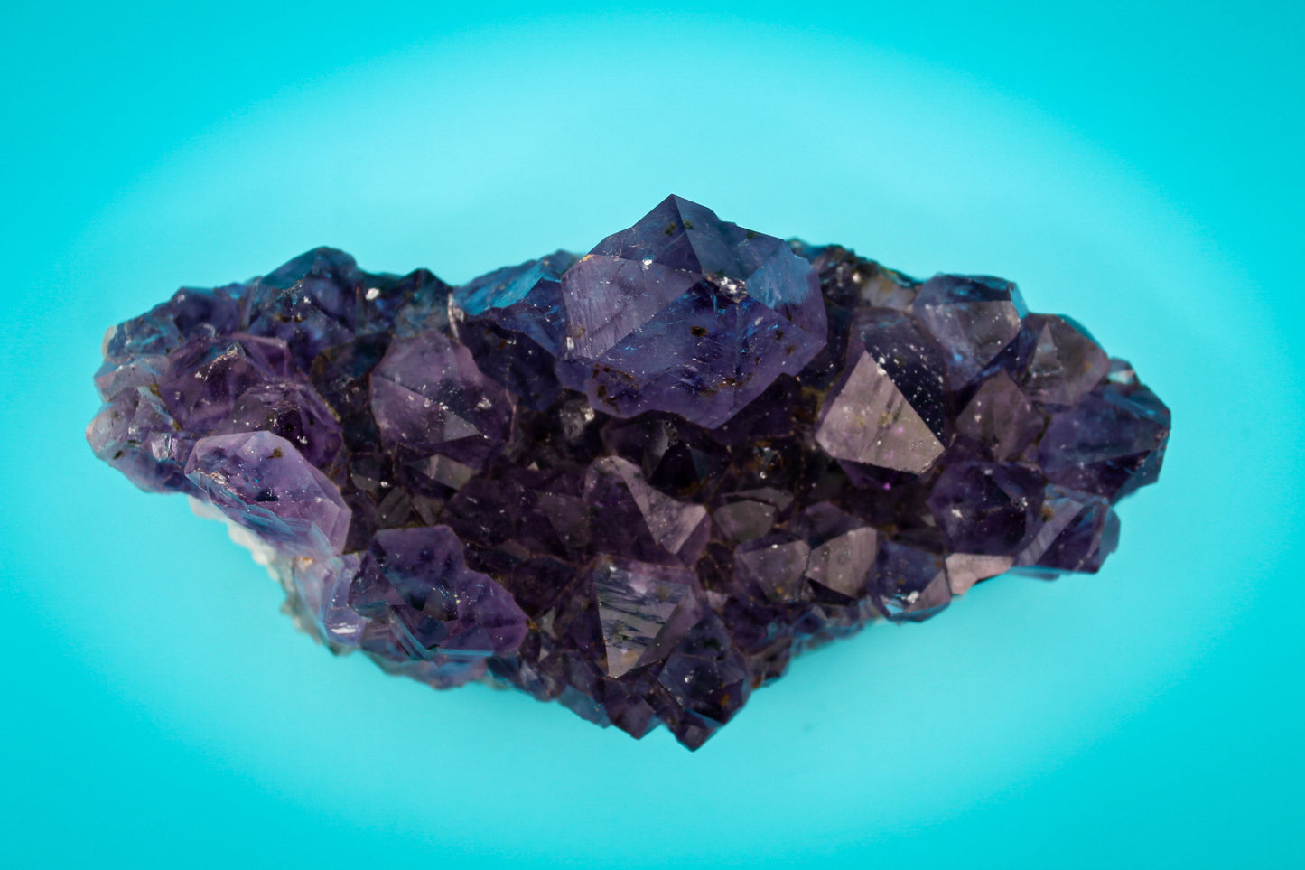 A cluster of amethyst crystals with a deep purple color.