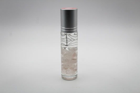 A clear roll-on bottle of essential oils, with the intention of "love"