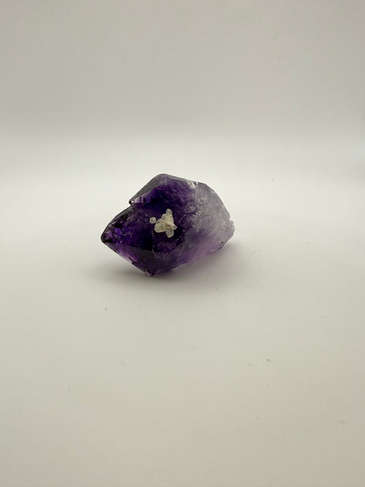 Amethyst crystal with calcite and deep purple color.