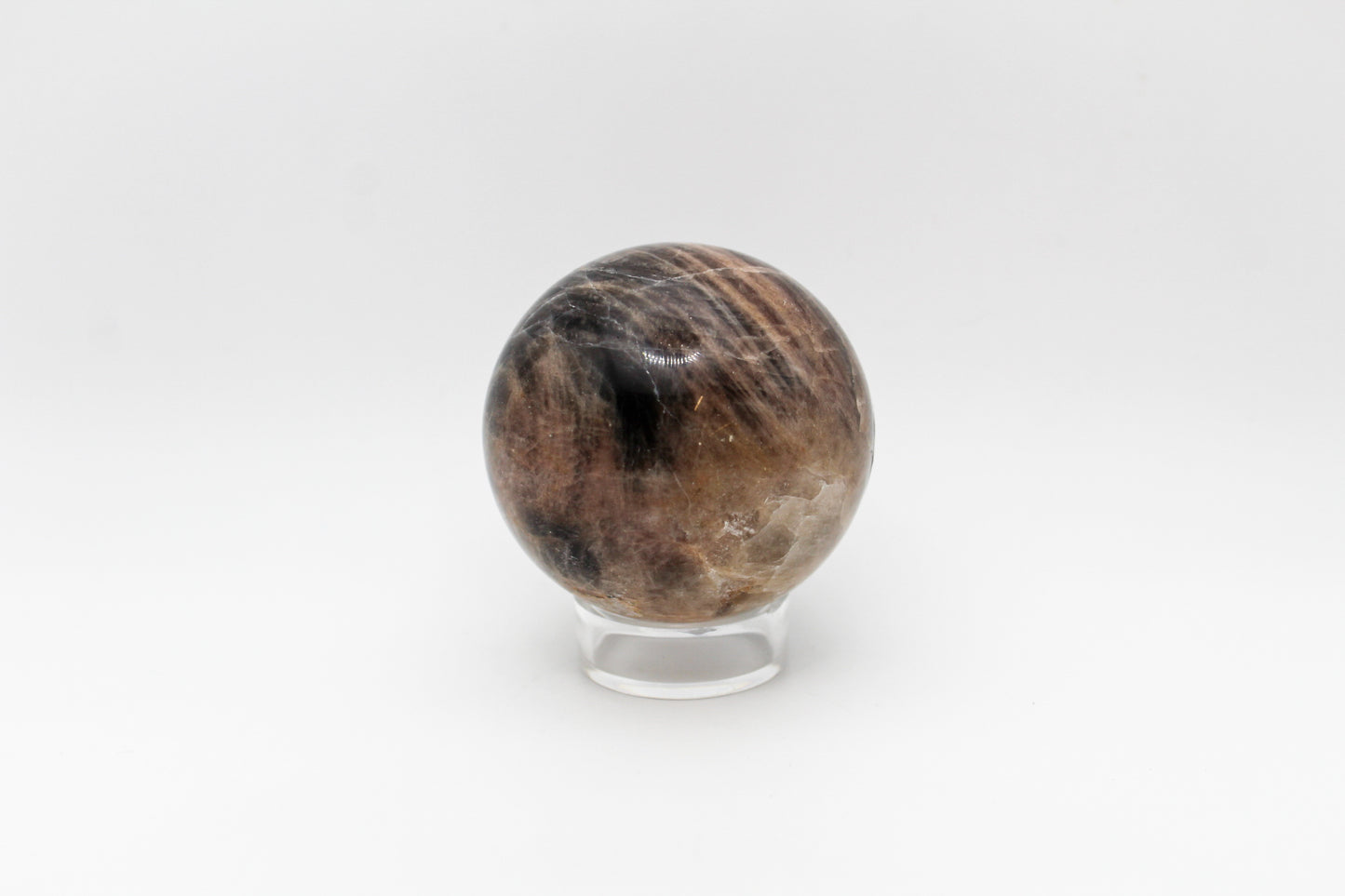 A polished black moonstone sphere.