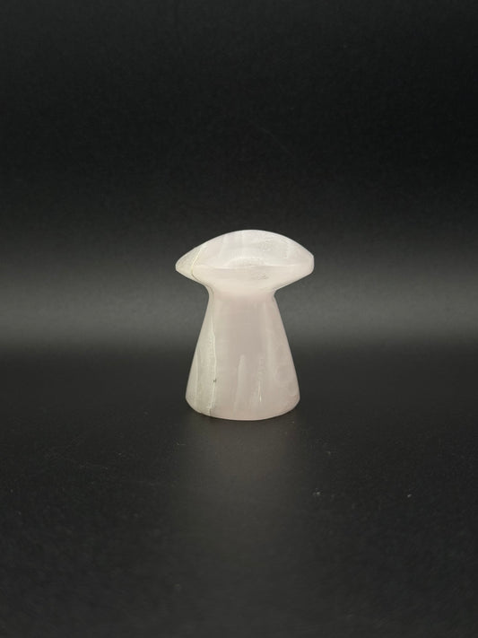 Polished pink calcite mushroom. Pink calcite glows under uv light.