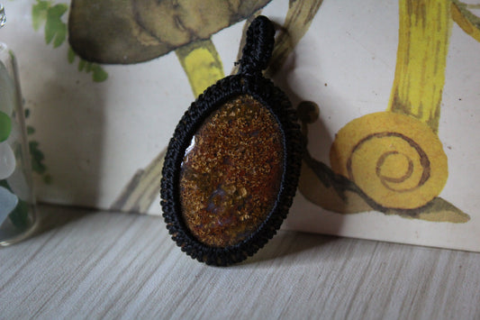 A red moss agate stone macrame style pendant.