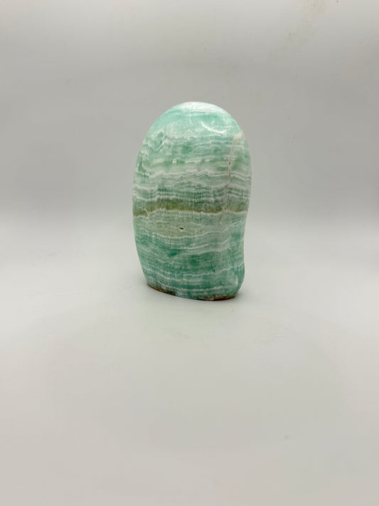 Caribbean calcite polished crystal free form in the shape of a dome.