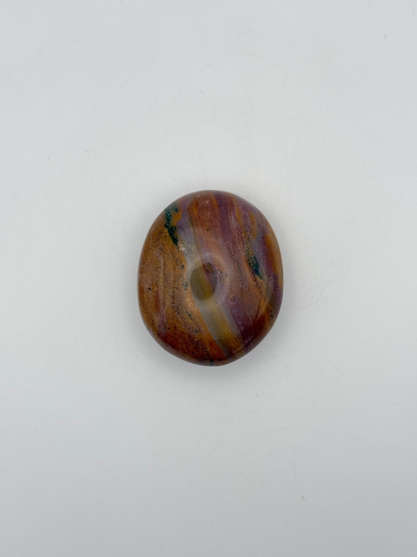 Polished ocean jasper palm stone.
