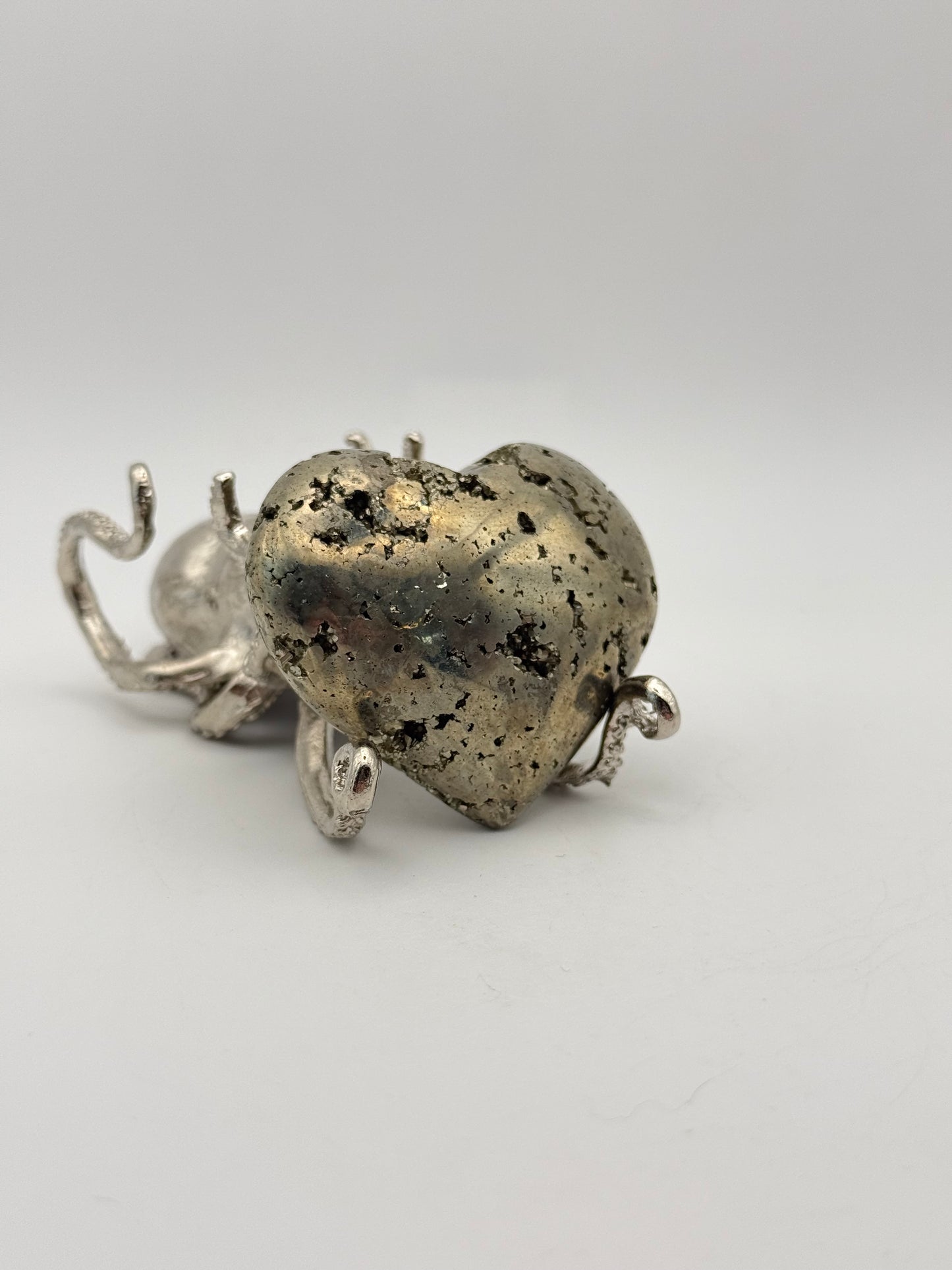 Polished pyrite crystal in the shape of a heart.