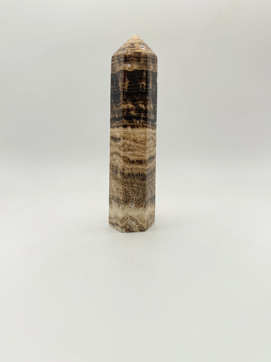 Polished chocolate calcite crystal tower. about 5 inches tall.