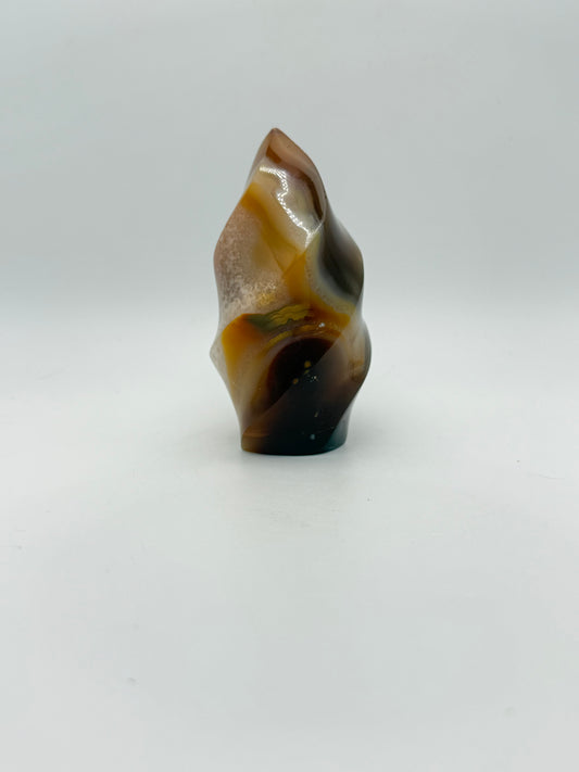 A polished carnelian stone with a flame shape, featuring an orange to red gradient color.