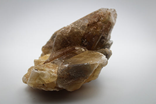 Raw dog tooth calcite crystal cluster.