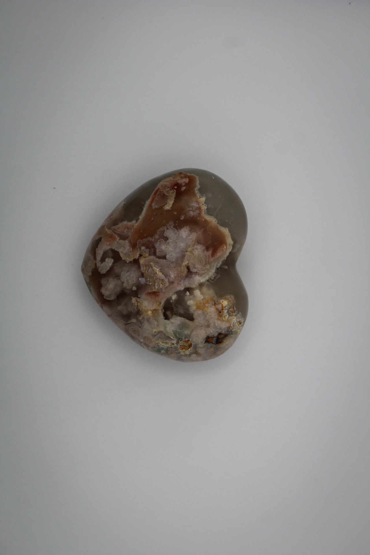 Polished flower agate in the shape of a heart.