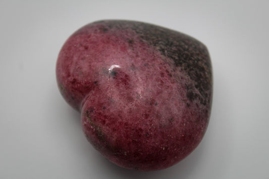 Polished Rhodonite heart.