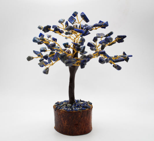 A decorative tree made of lapis lazuli with gold pyrite, mounted on a cylindrical base.