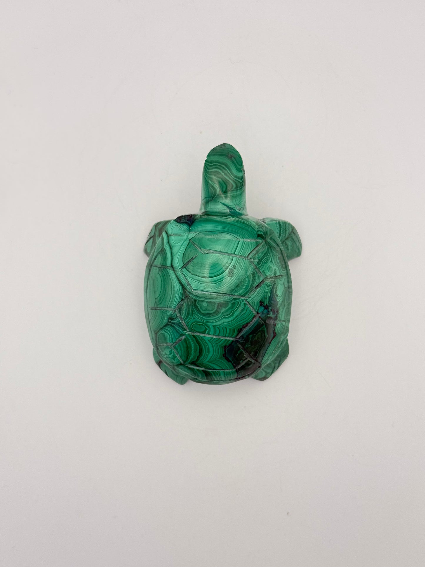Vibrant green malachite stone carving of a turtle.