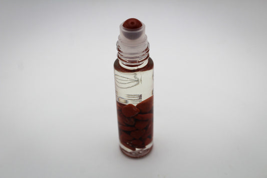 Roll on bottle with essential oils and crystals with the intention of passion.