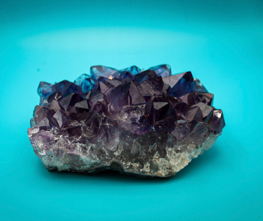 A cluster of amethyst crystals with a deep purple color.