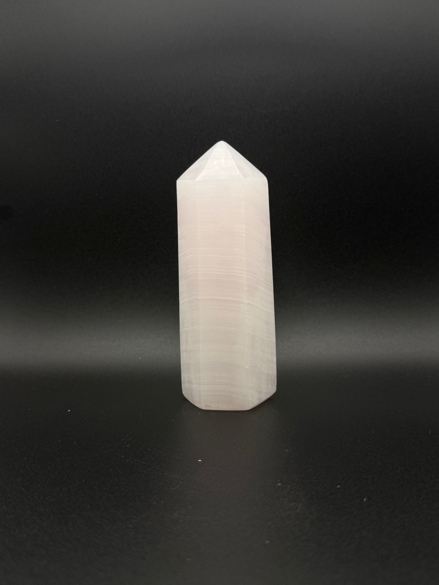 Polished pink calcite tower. Pink calcite glows under uv light.