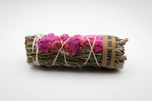 A bundle of sage with pink flowers and pine.