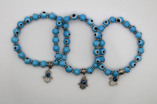 Evil eye bracelets sky blue in color with an evil eye charm attached.