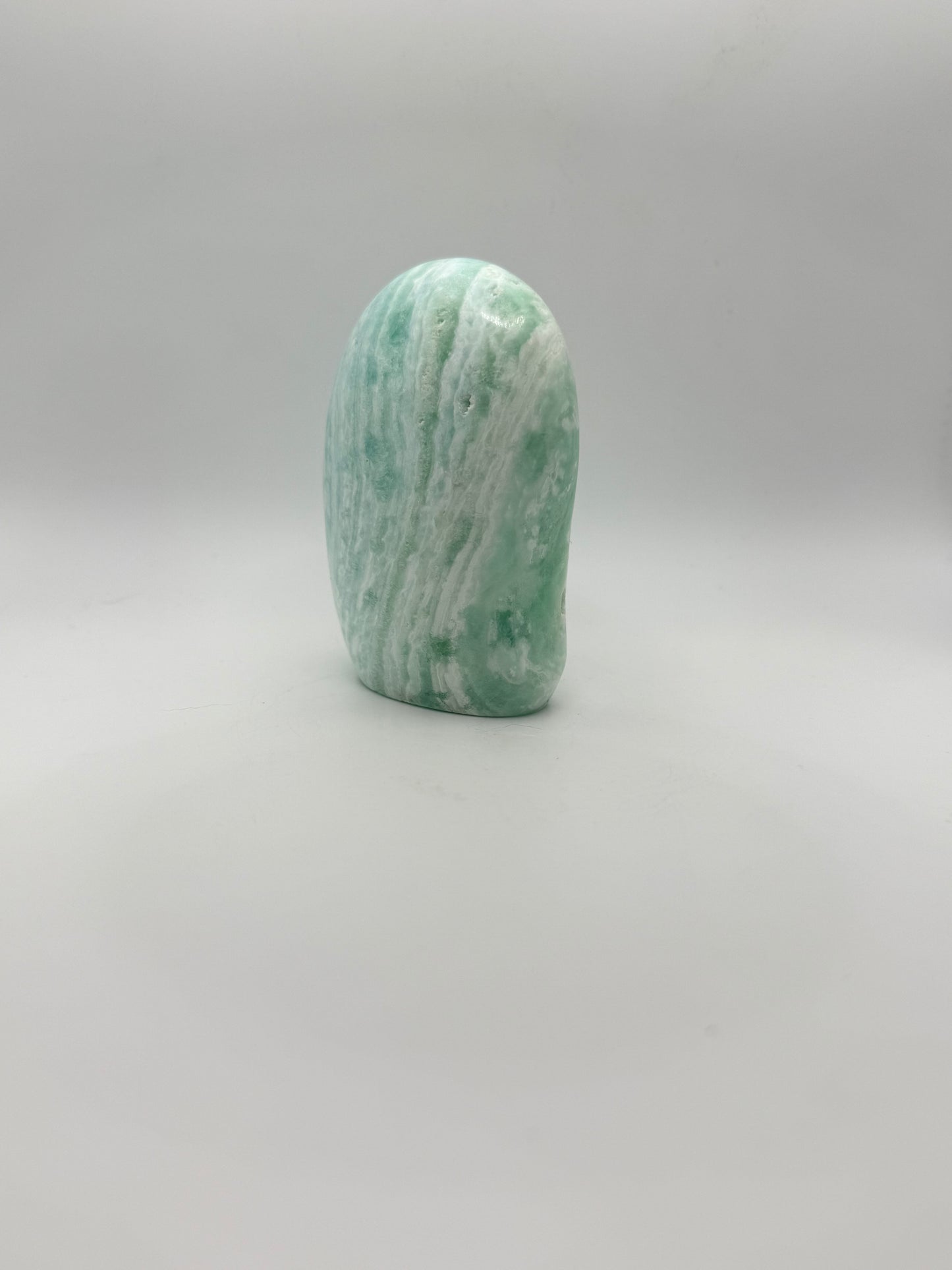 Caribbean calcite polished crystal free form in the shape of a dome.