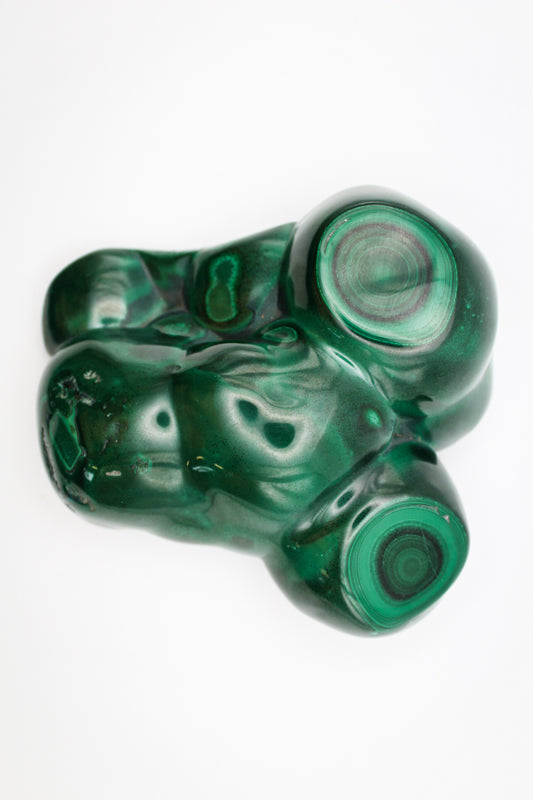 A large malachite free form with vibrant green color and distinctive swirling patterns.
