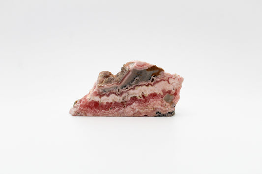 A polished rhodochrosite crystal slice.