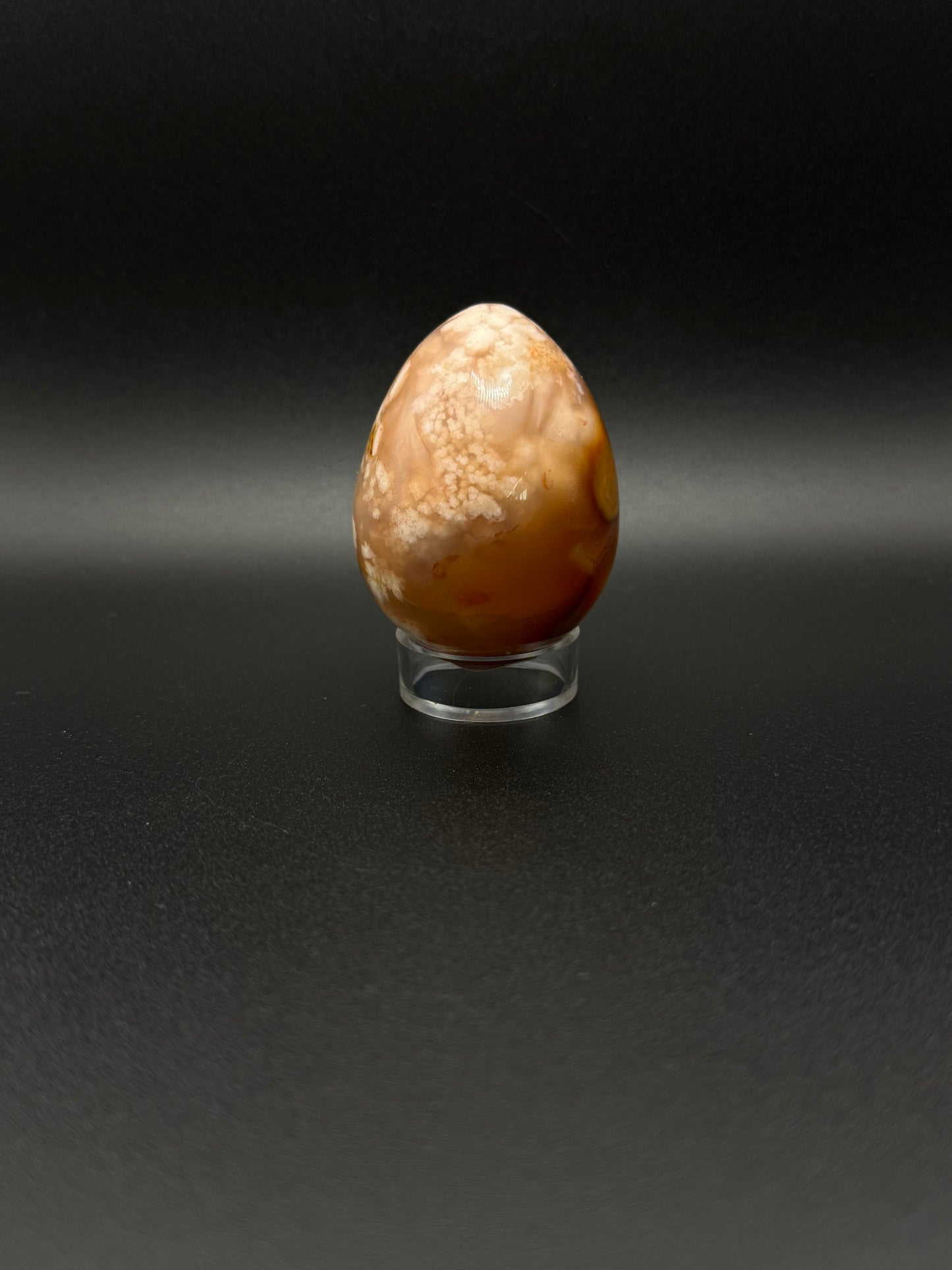 Flower Agate polished crystal in the shape of an egg.