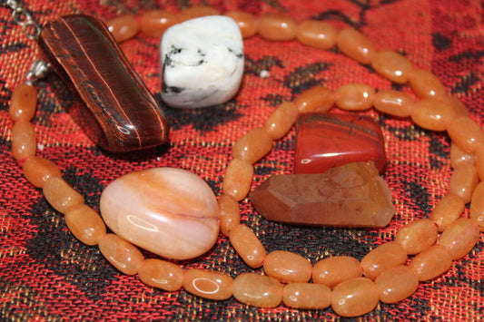 This bag of crystals is to help you with your creativity. It contains a tangerine point and a carnelian necklace. Also included is a carnelian tumble, moonstone tumble, poppy jasper tumble, an a red tigers eye tumble.