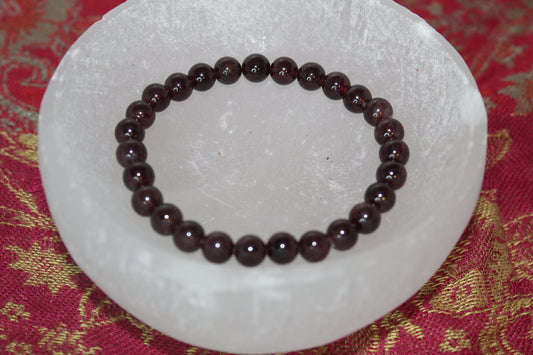 A series of round garnet bead bracelets 8mm in size.