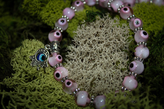 Collection of pink evil eye bracelets.