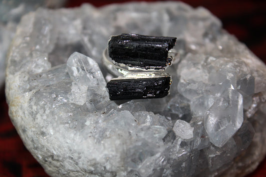 An adjustable black tourmaline ring set in stainless steel.
