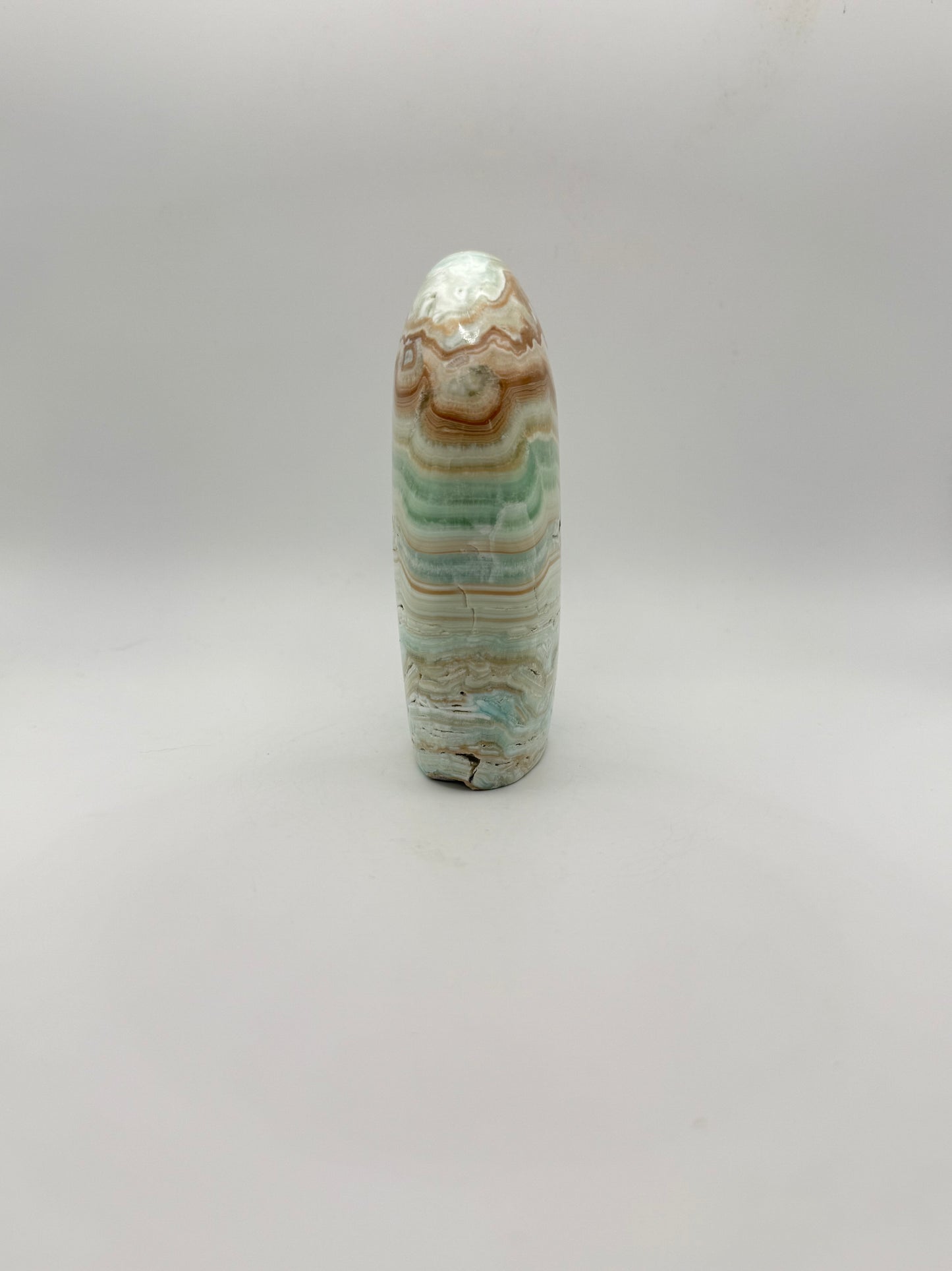Caribbean calcite polished crystal free form in the shape of a dome.