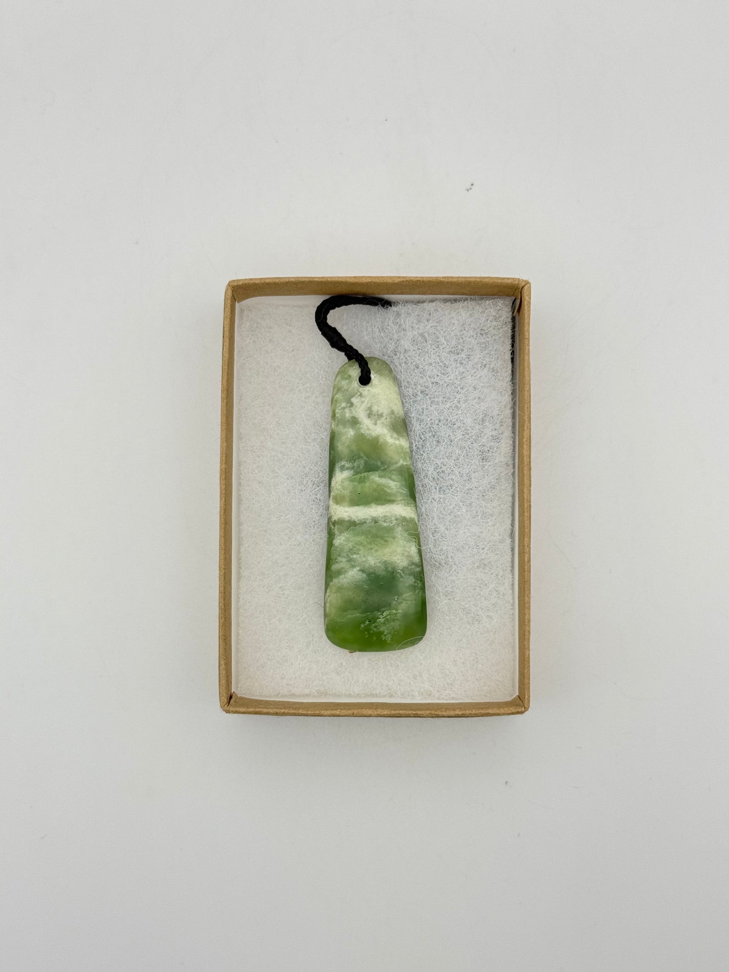 Green Jade pendant with string necklace.