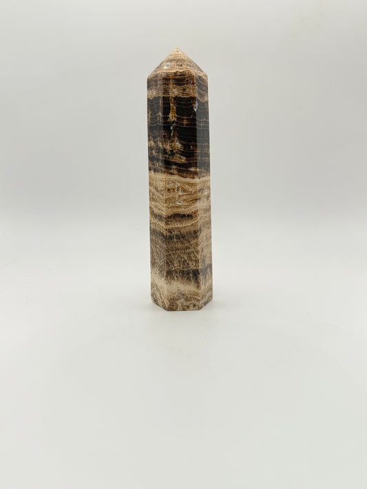 Polished chocolate calcite crystal tower. about 5 inches tall.