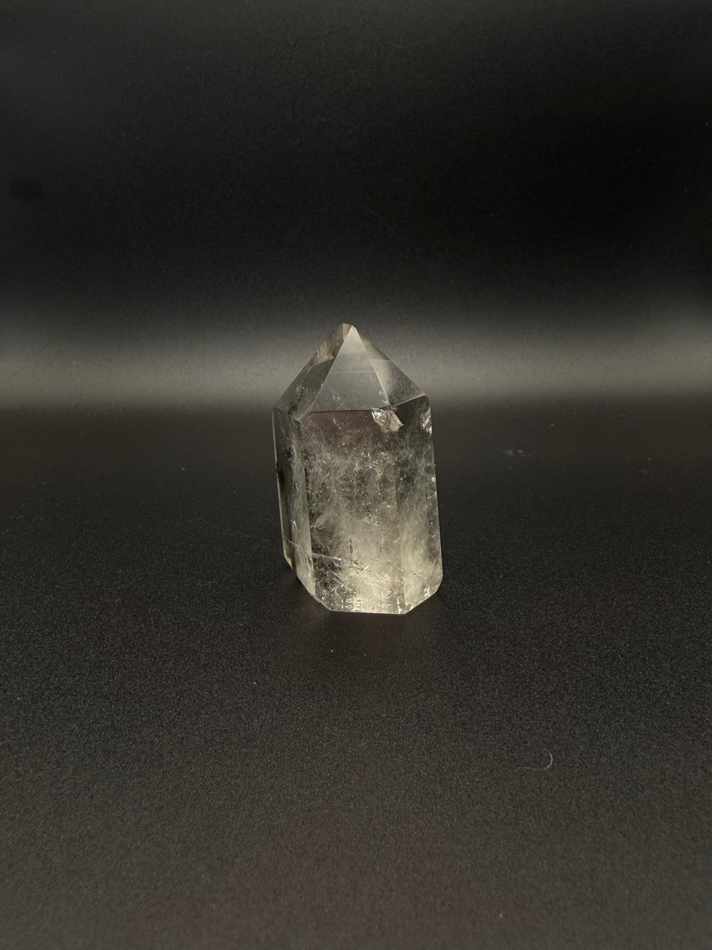 Polished garden quartz crystal tower with six sides.