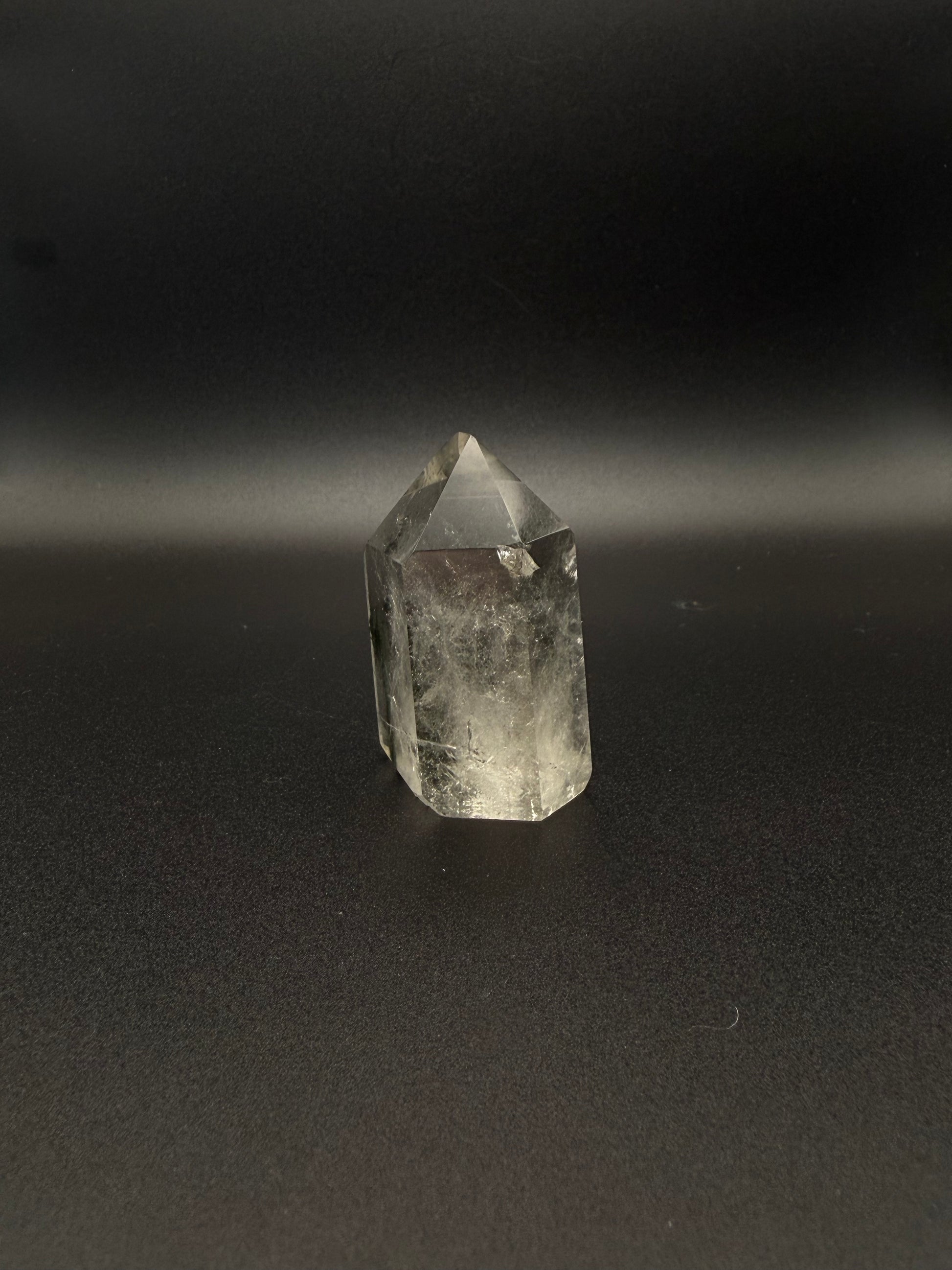 Polished garden quartz crystal tower with six sides.