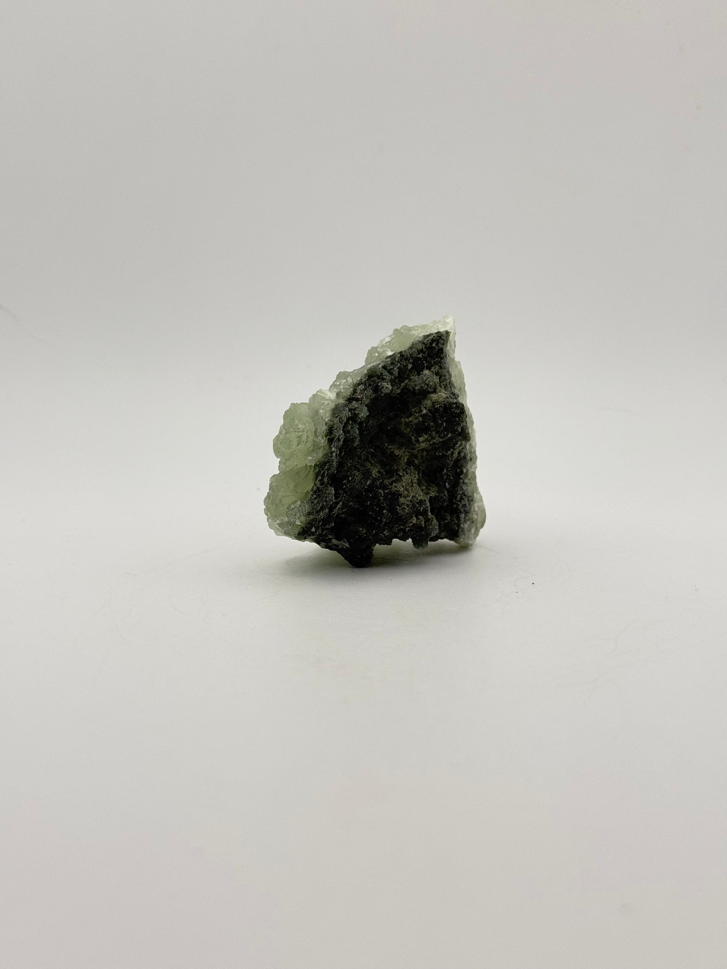 Raw Prehnite specimen with amazing green color.