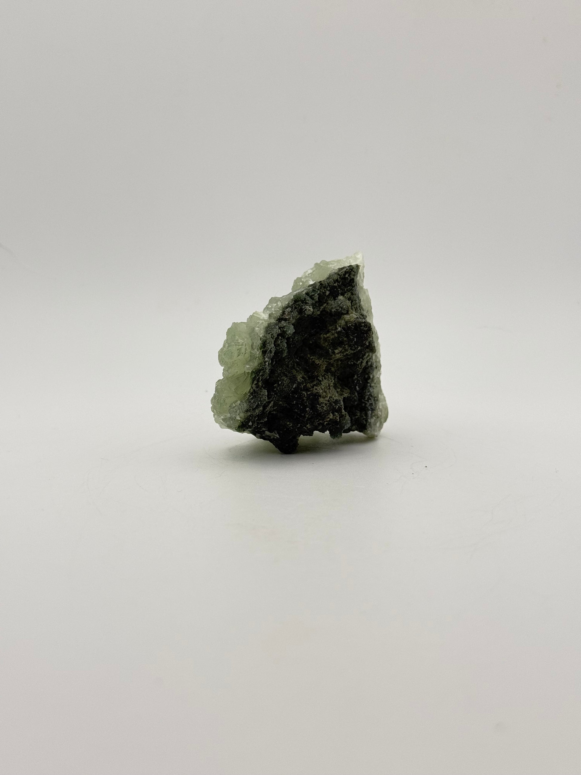 Raw Prehnite specimen with amazing green color.