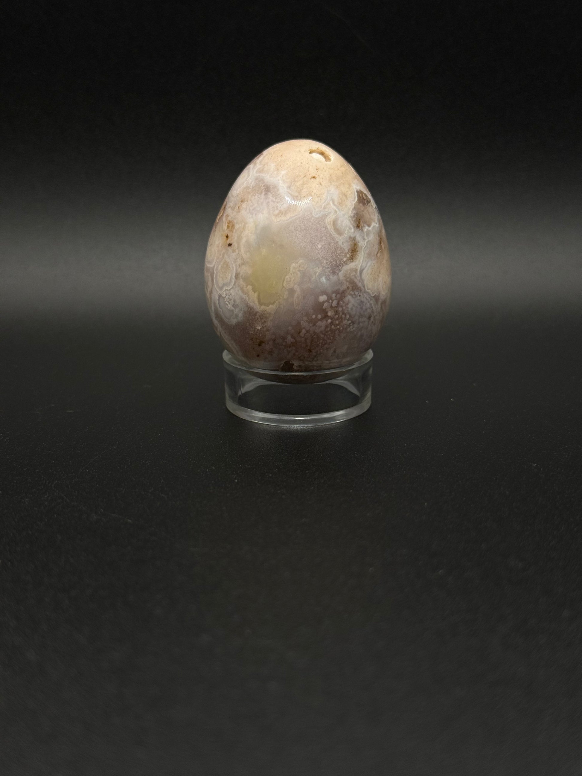 Polished flower agate crystal in the shape of an egg.
