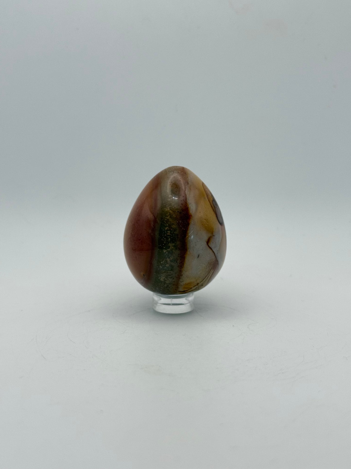 Polished polychrome jasper shaped into an egg.
