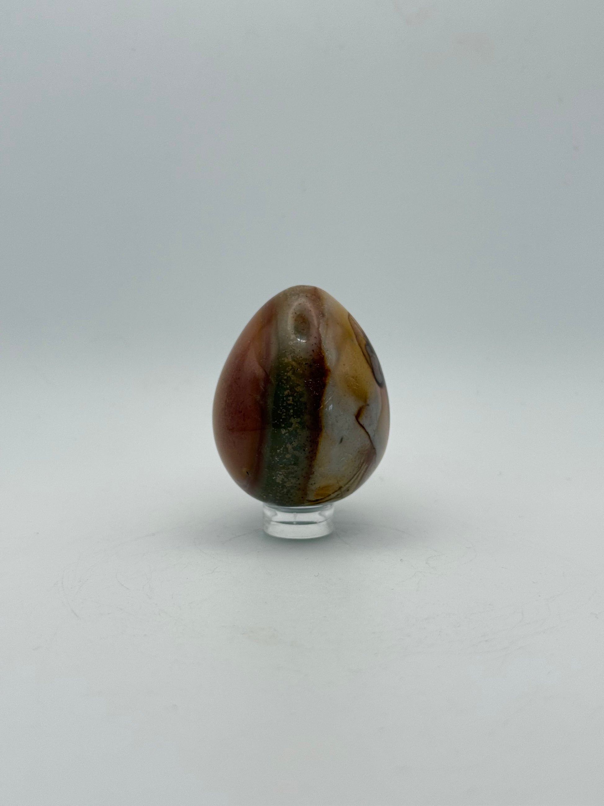 Polished polychrome jasper shaped into an egg.